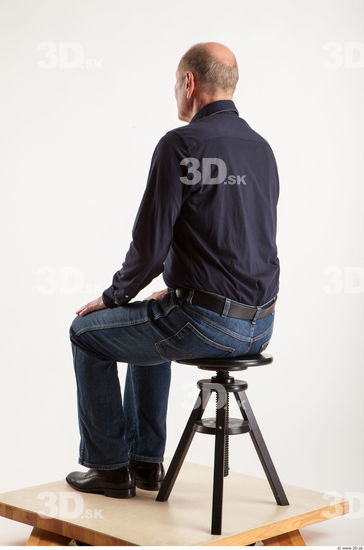 Sitting pose blue deep shirt jeans of Ed