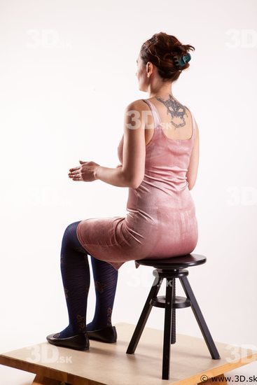 Sitting reference of whole body pink dress purple tights black shoes Nadine