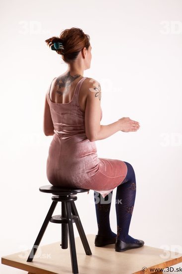 Sitting reference of whole body pink dress purple tights black shoes Nadine