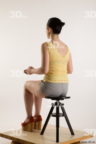 Sitting reference of whole body yellow t shirt gray shorts red shoes Hazel