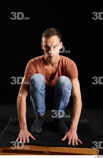 Alessandro Katz  black shoes blue jeans brown t shirt casual dressed kneeling whole body  jpg