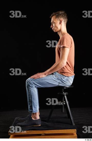 Alessandro Katz  black shoes blue jeans brown t shirt casual dressed sitting whole body  jpg