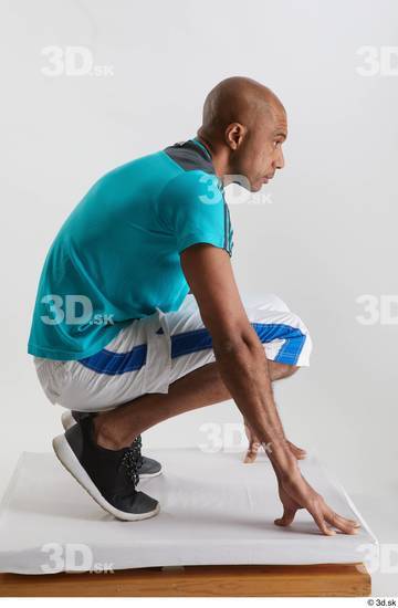 Whole Body Man Black Sports Shirt Shorts Slim Kneeling Studio photo references