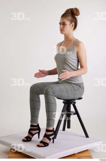 Olivia Sparkle  black high heels sandals casual dressed grey checkered trousers grey tank top sitting whole body  jpg