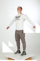 Joel a-pose dressed green sneakers grey jogger pants sports standing…