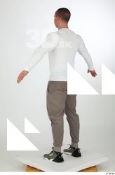 Joel a-pose dressed green sneakers grey jogger pants sports standing…