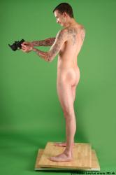 Whole Body Man Pose with pistol White Tattoo Nude Underweight Male Studio Poses