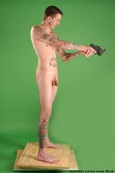 Whole Body Man Pose with pistol White Tattoo Nude Underweight Male Studio Poses