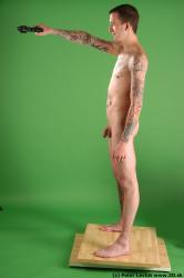 Whole Body Man Pose with pistol White Tattoo Nude Underweight Male Studio Poses